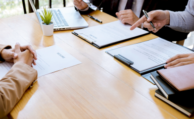 Desk with candidate appearing to interview.