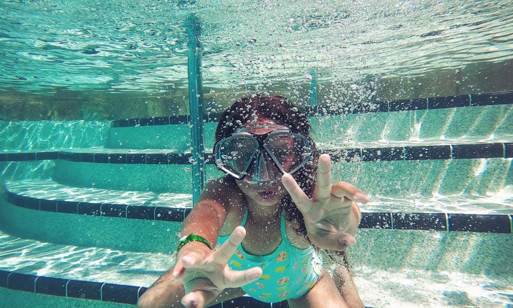 Girl swimming underwater in a pool