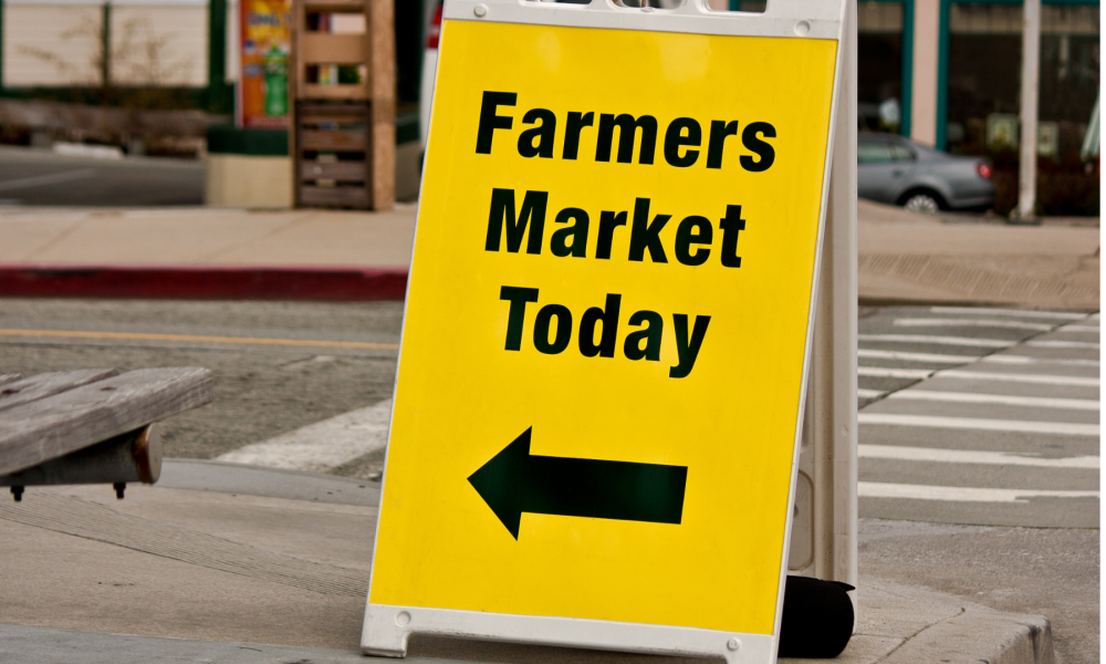 Yellow A-Frame Sign with Farmers Market Today in black text