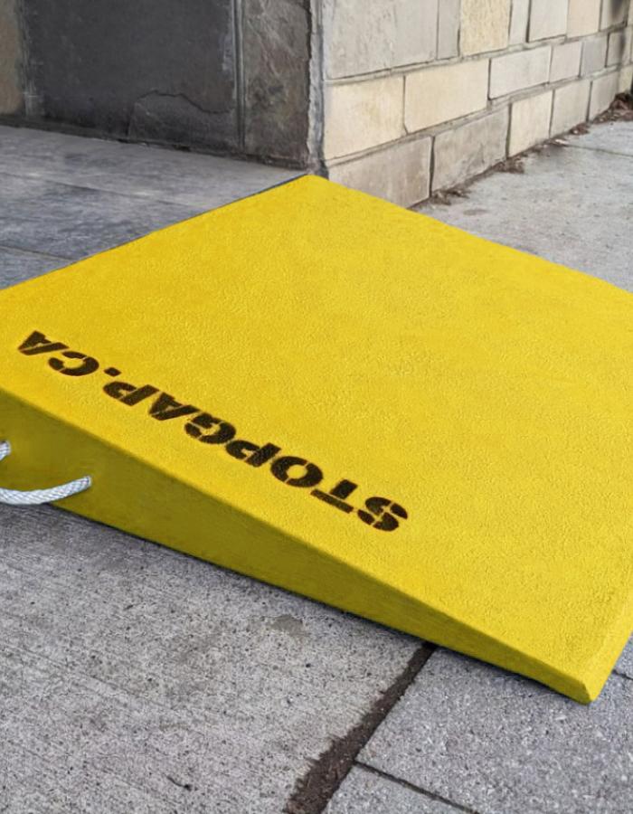 A yellow StopGap ramp installed in front of a store allowing everyone the ability for entry.