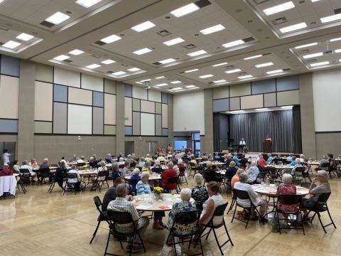 Image of in-person gathering at the Niagara-on-the-Lake Community Centre for the Strawberry Social event.