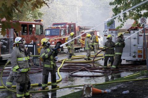 Image of Niagara-on-the-Lake firefighters hosing down a fire. 