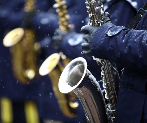 Image of person playing saxophone in the winter. 