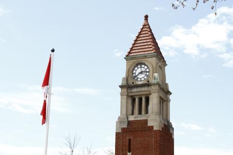 Canadian Flag and Old Town Cenotaph with clock tower