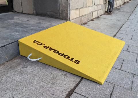 A StopGap ramp set up in front of a storefront.
