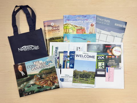 The contents of the town's new resident welcome package laid out on a table.